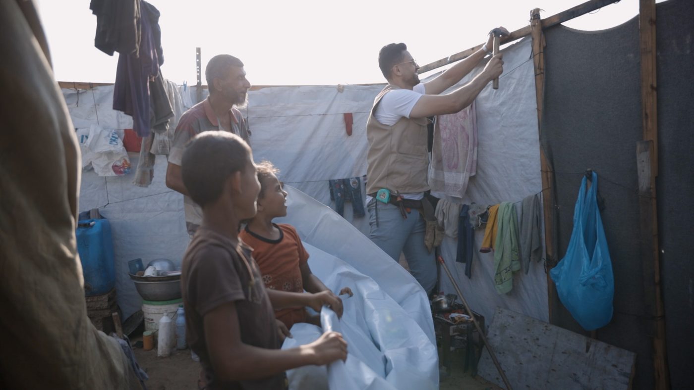Tarpaulin being prepared for shelter