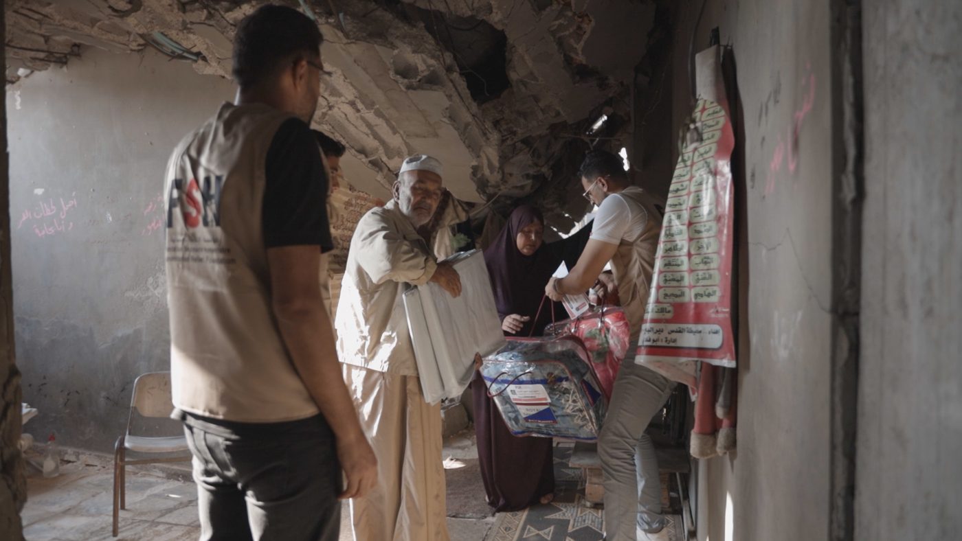 FSH team delivering winter supplies to an older man in Gaza